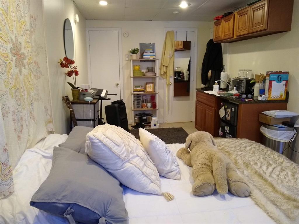 507 Beacon Street, Unit C Boston, MA 02215 - Photo 3 of 5 a bedroom with a bed and a refrigerator