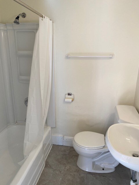507 Beacon Street, Unit C Boston, MA 02215 - Photo 5 of 5 a white toilet sitting next to a bath tub