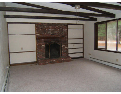 276 Pommogussett Road Rutland, MA 01543 - Photo 17 of 20 a view of an empty room with a fireplace and a window