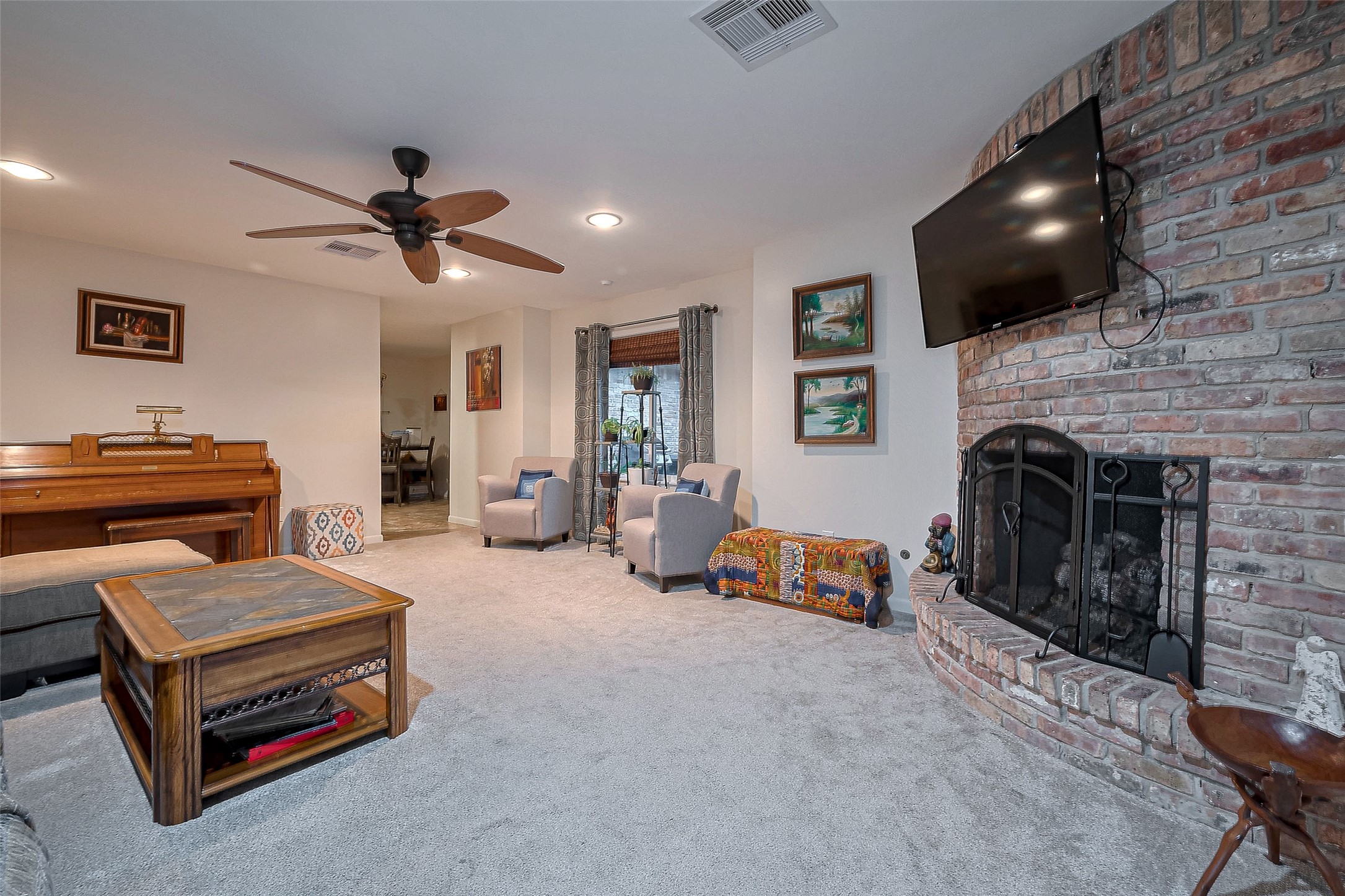 8019 Colgate Street Houston, TX 77061 - Photo 5 of 27 Family room is the heart of the home with plenty of space for large furniture, a piano, and a gorgeous corner brick fireplace