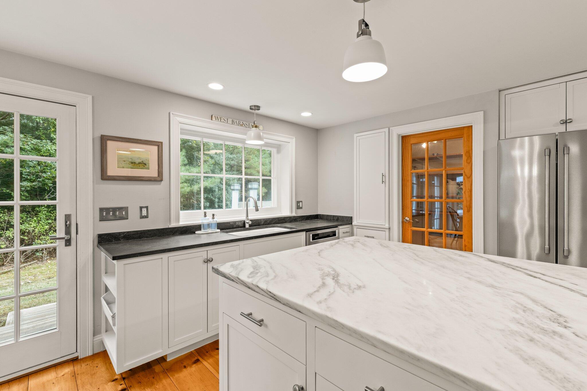 1756 Osterville West Barnstable Road West Barnstable, MA 02668 - Photo 12 of 62 a kitchen with granite countertop a sink and dishwasher with wooden floor