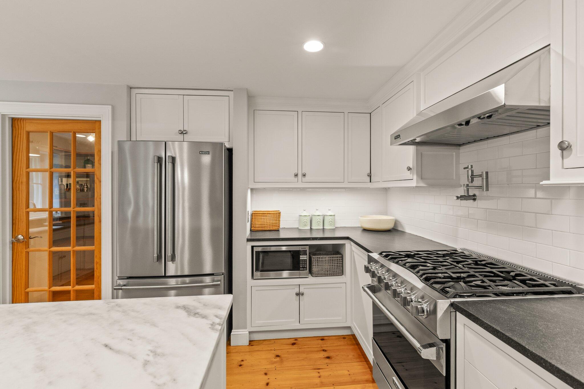 1756 Osterville West Barnstable Road West Barnstable, MA 02668 - Photo 14 of 62 a kitchen with stainless steel appliances granite countertop a stove and a refrigerator