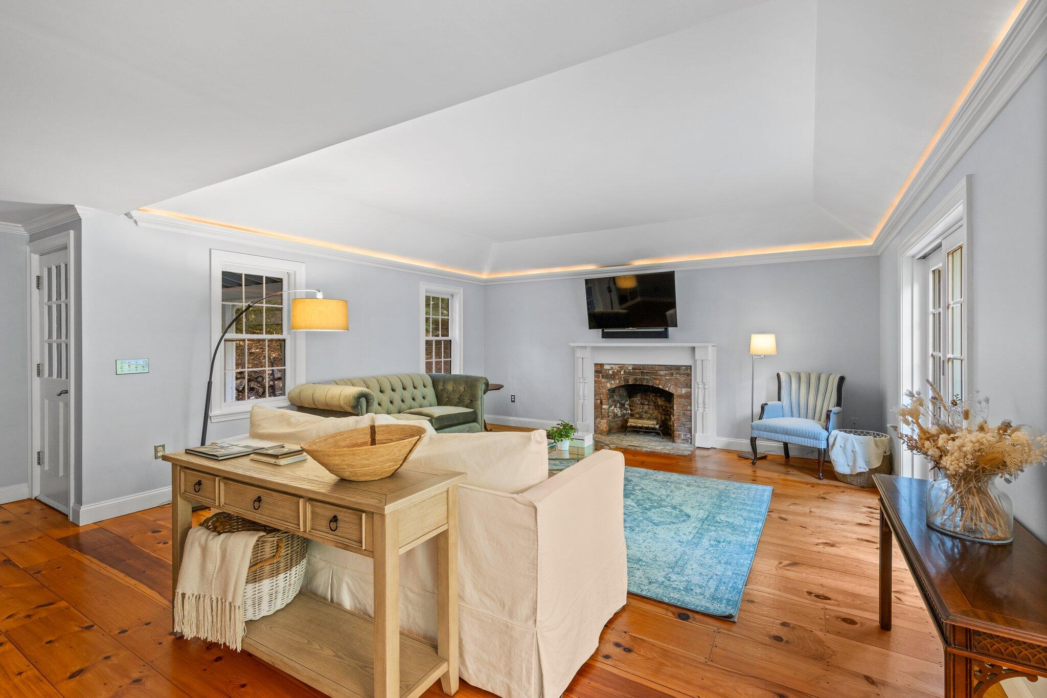 1756 Osterville West Barnstable Road West Barnstable, MA 02668 - Photo 19 of 62 a living room with furniture a fireplace and a flat screen tv
