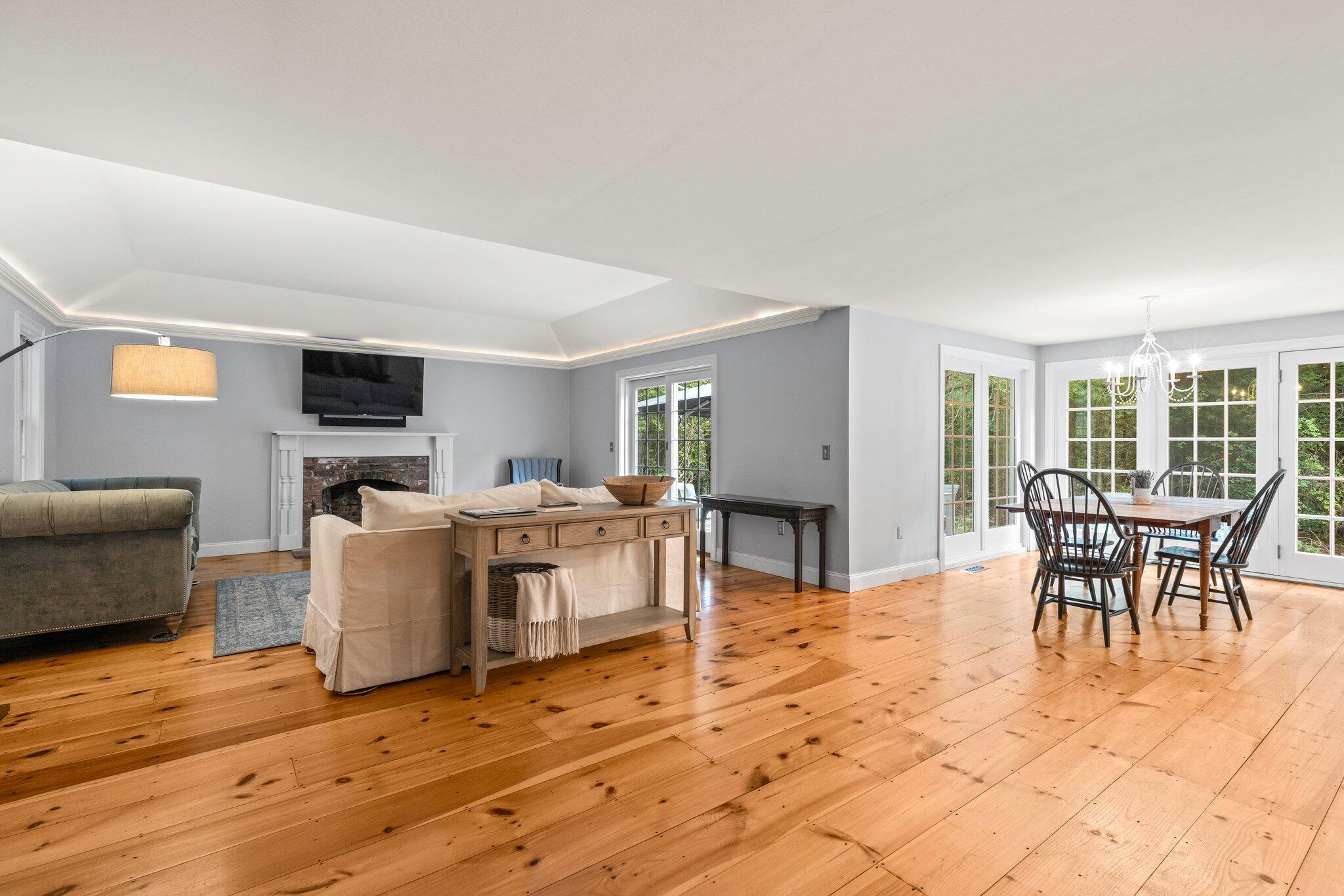 1756 Osterville West Barnstable Road West Barnstable, MA 02668 - Photo 25 of 62 a living room with furniture a dining table and a fireplace