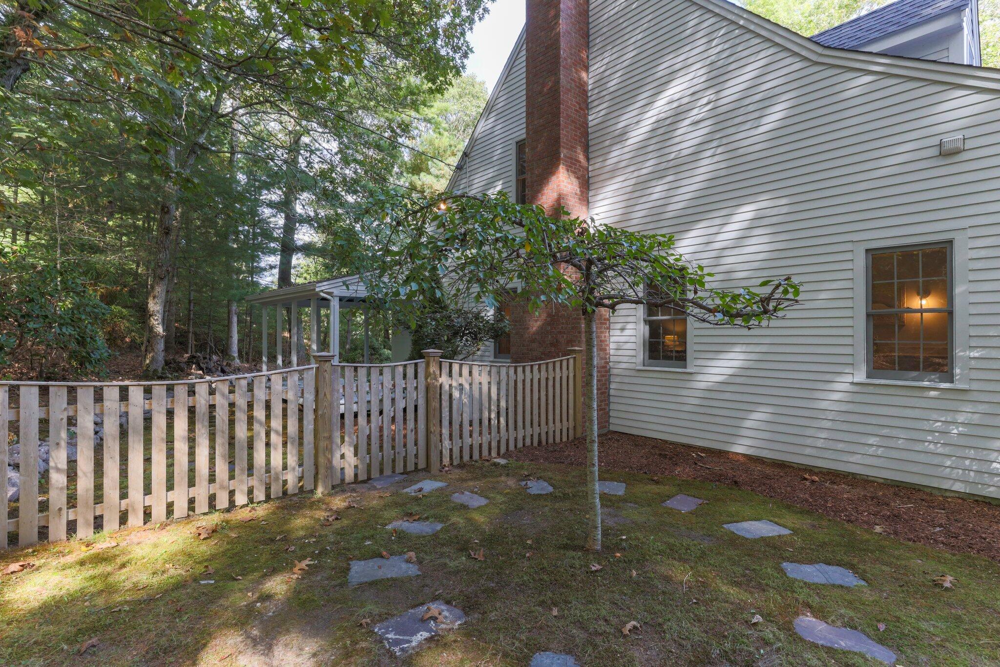 1756 Osterville West Barnstable Road West Barnstable, MA 02668 - Photo 54 of 62 a view of a house with a small yard and a large tree