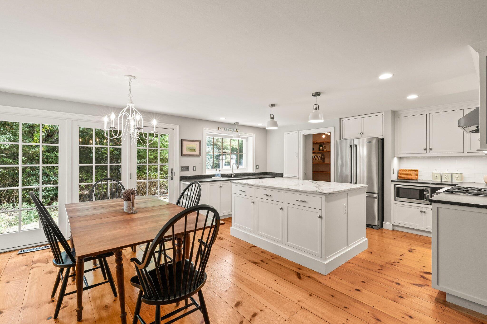 1756 Osterville West Barnstable Road West Barnstable, MA 02668 - Photo 10 of 62 a kitchen with stainless steel appliances granite countertop a stove a sink a refrigerator dining table and chairs