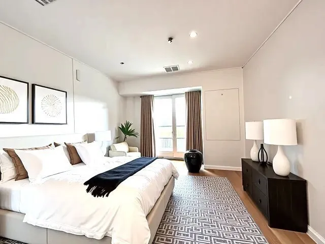 a bedroom with a bed and a lamp