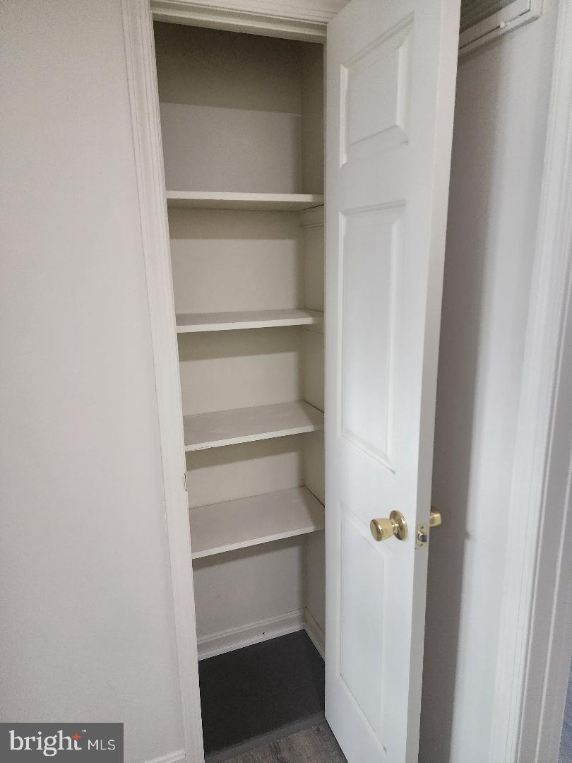 130-134 West 13th Street, Unit 134 Front Royal, VA 22630 - Photo 14 of 21 a view of walk in closet with empty racks