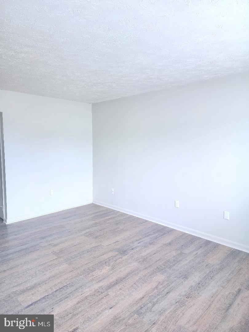 130-134 West 13th Street, Unit 134 Front Royal, VA 22630 - Photo 2 of 21 a view of an empty room and wooden floor
