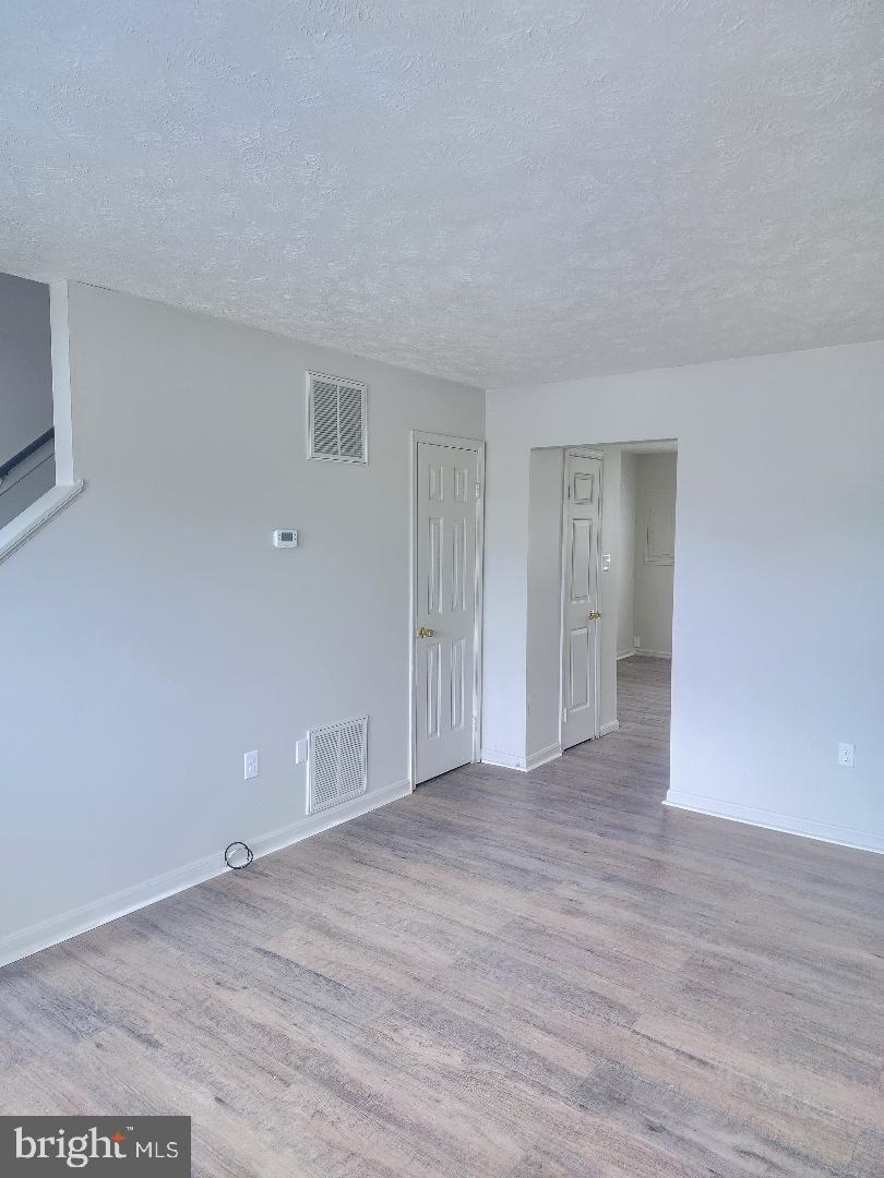 130-134 West 13th Street, Unit 134 Front Royal, VA 22630 - Photo 5 of 21 a view of an empty room and wooden floor