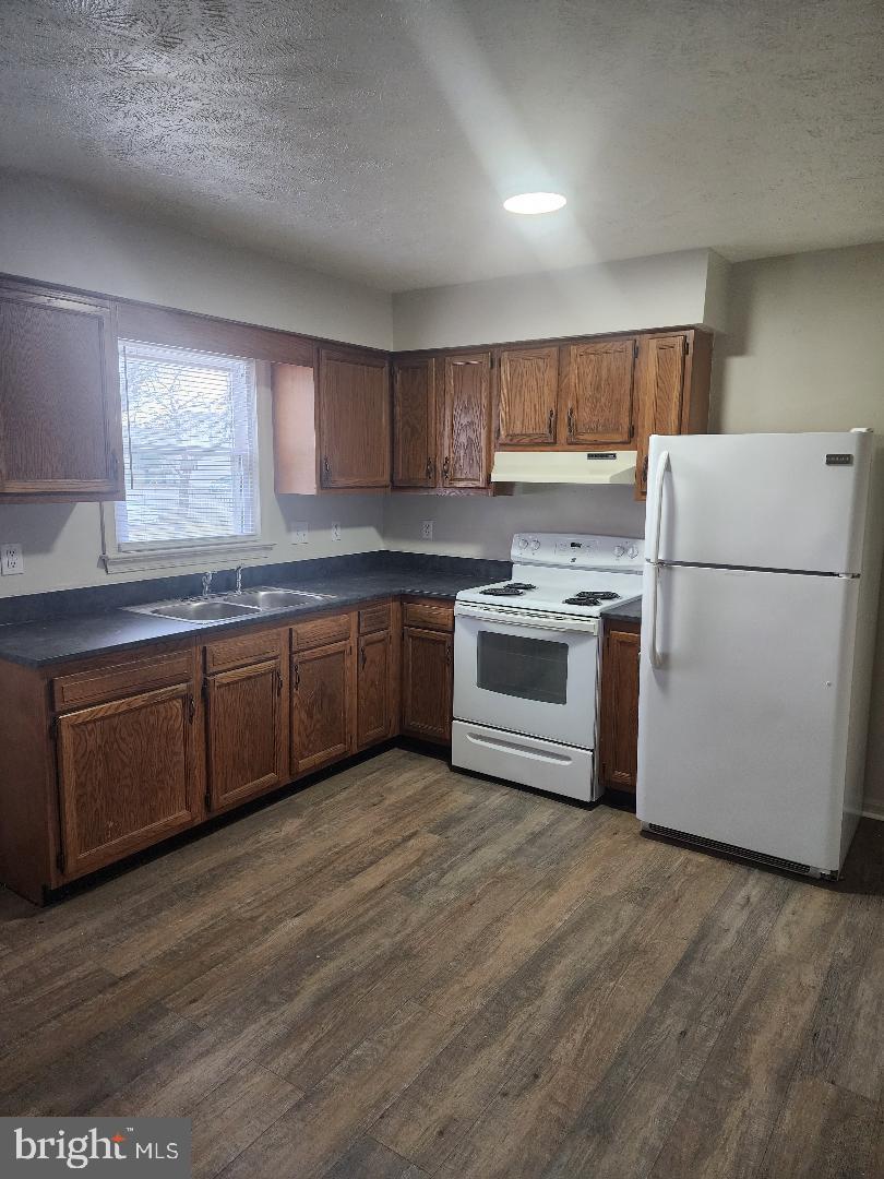 130-134 West 13th Street, Unit 134 Front Royal, VA 22630 - Photo 6 of 21 a kitchen with a white cabinets and white appliances