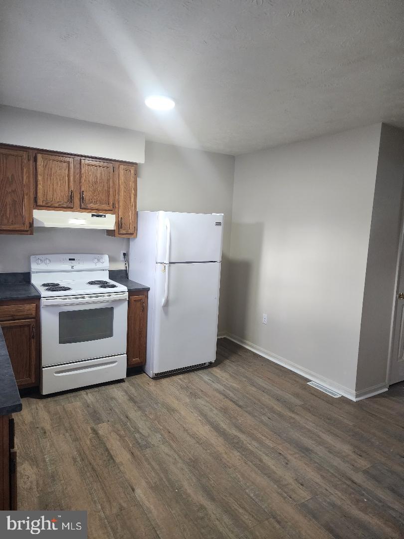 130-134 West 13th Street, Unit 134 Front Royal, VA 22630 - Photo 8 of 21 a kitchen with a white stove top oven and white countertops