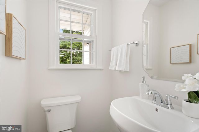 a bathroom with a sink a toilet and a window