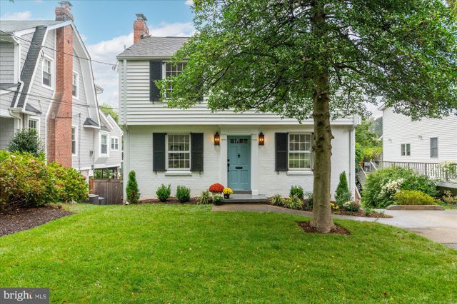 a front view of a house with garden and porch
