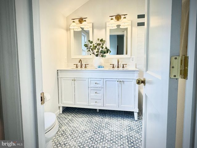 a bathroom with a double vanity sink and mirror