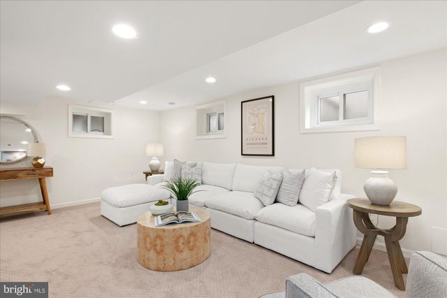 a living room with furniture and flowers