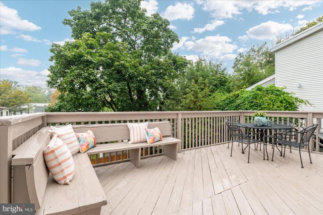 a balcony with wooden floor and fence
