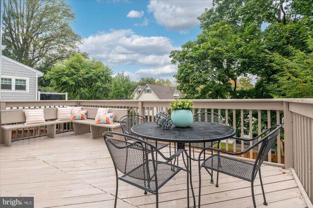 a view of a chairs and table in the roof deck