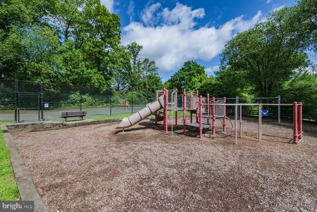 a view of outdoor space with playground and green space