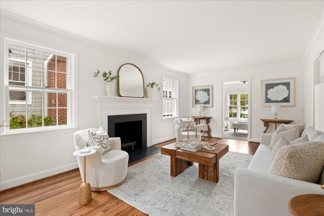 a living room with furniture a fireplace and a window