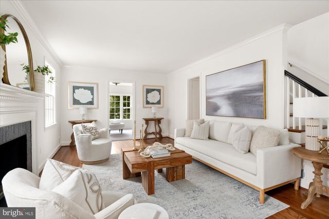 a living room with furniture a fireplace and a large window