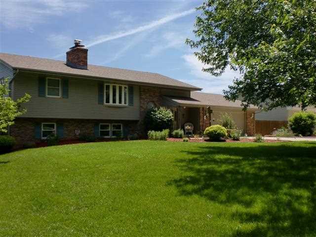 14877 Zahm Road Rockton, IL 61072 - Photo 1 of 15 a front view of a house with garden