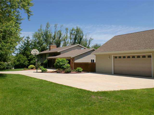 14877 Zahm Road Rockton, IL 61072 - Photo 2 of 15 a front view of house with yard and trees in the background