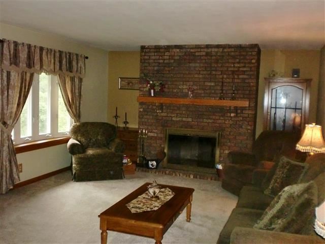 14877 Zahm Road Rockton, IL 61072 - Photo 9 of 15 a living room with furniture and a fireplace