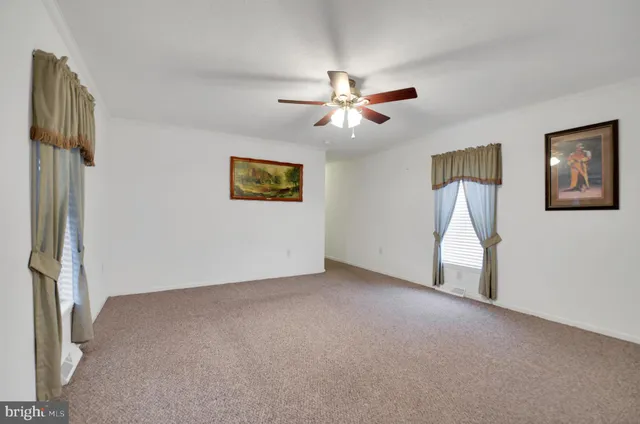 a view of empty room with ceiling fan