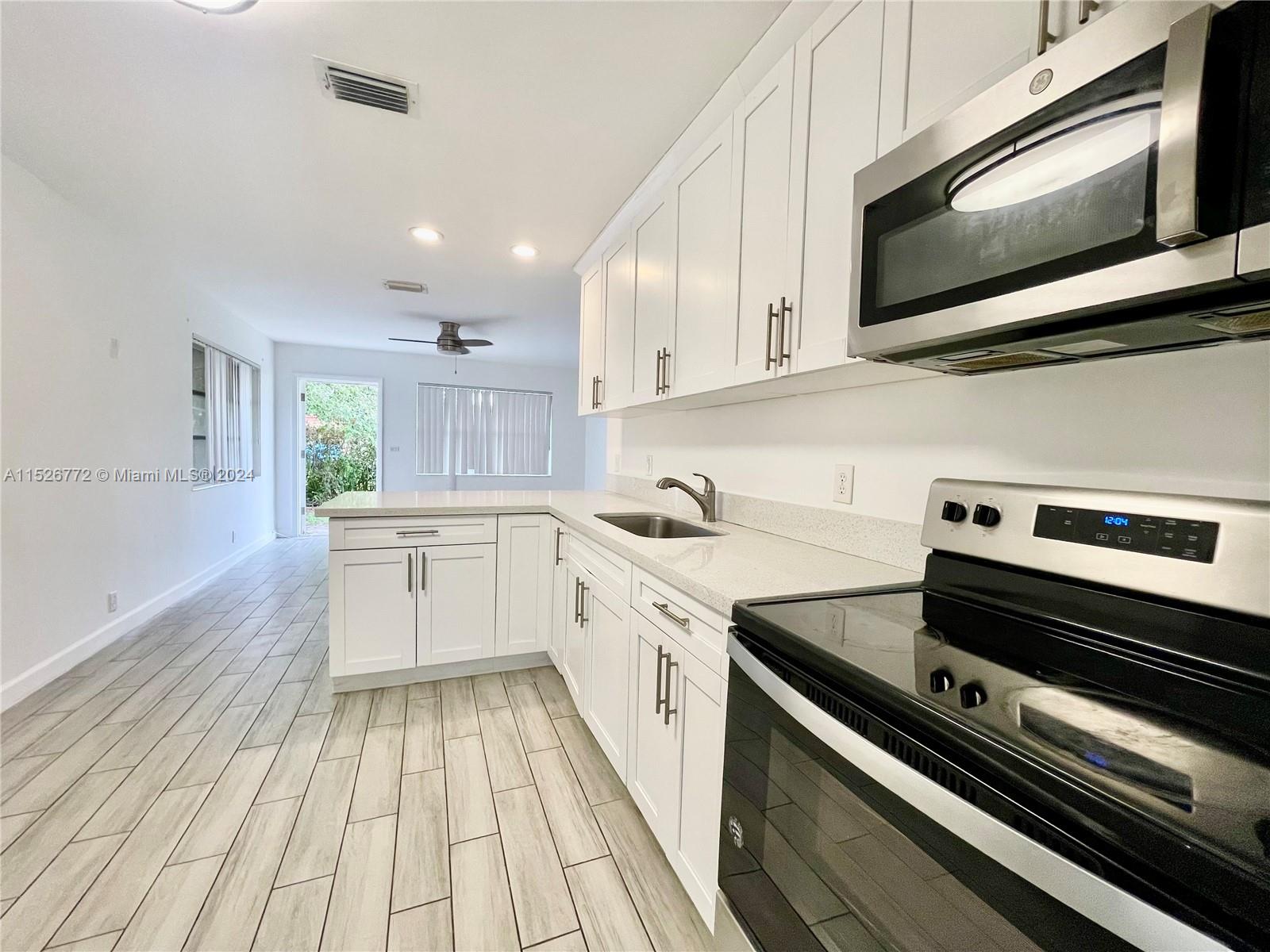 a kitchen with a stove microwave and cabinets