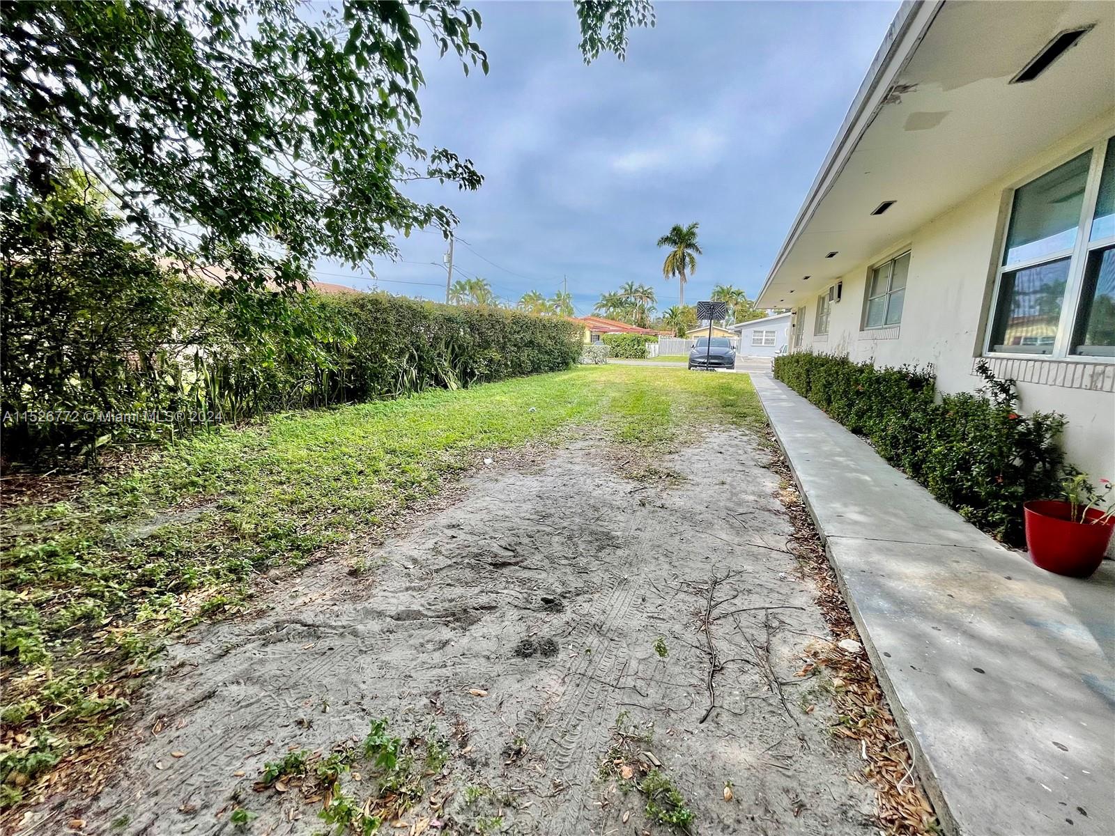 215 Southwest 10th Street Hallandale Beach, FL 33009 - Photo 15 of 18 a view of a yard with plants