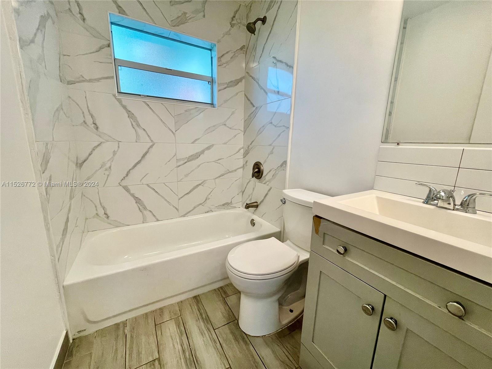 215 Southwest 10th Street Hallandale Beach, FL 33009 - Photo 9 of 18 a bathroom with a sink toilet and shower