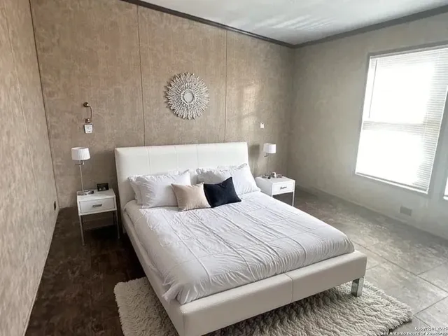 a bedroom with bed and window