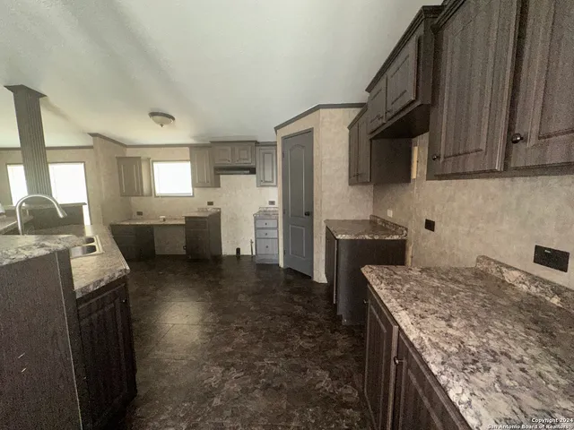 a kitchen with cabinets and refrigerator