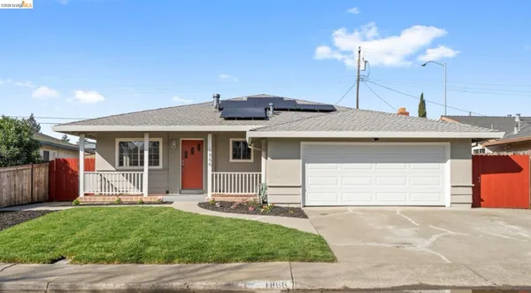 a front view of a house with a garden and yard
