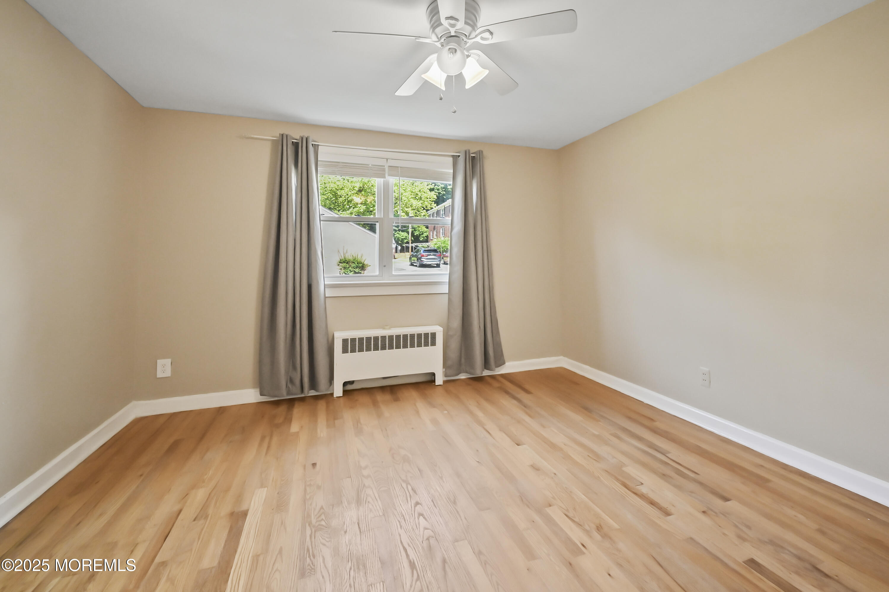 82 Manor Drive, Unit 803 Red Bank, NJ 07701 - Photo 12 of 19 wooden floor in an empty room with a window