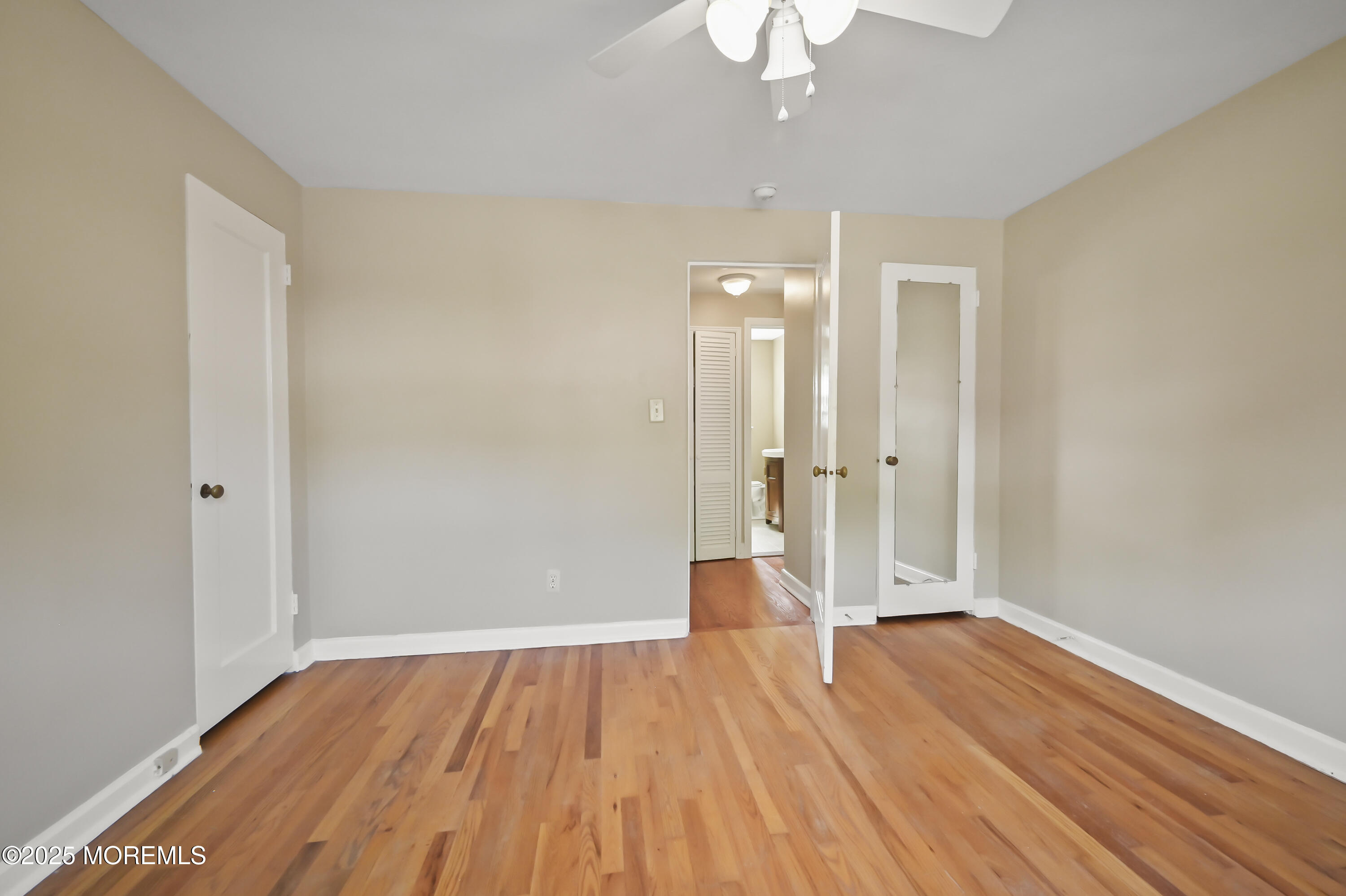 82 Manor Drive, Unit 803 Red Bank, NJ 07701 - Photo 13 of 19 wooden floor in an empty room with a window