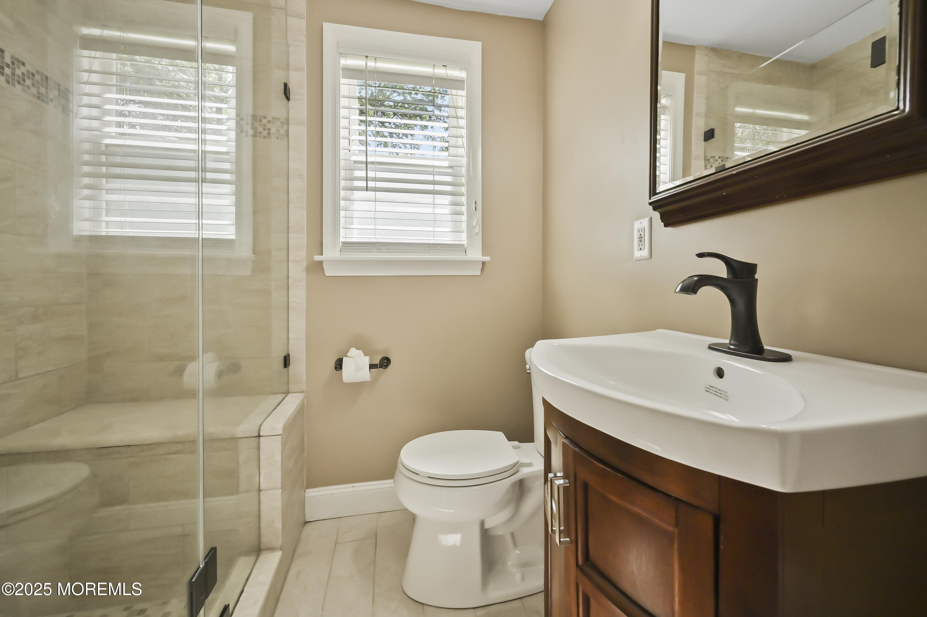 82 Manor Drive, Unit 803 Red Bank, NJ 07701 - Photo 14 of 19 a bathroom with a sink a toilet and a mirror