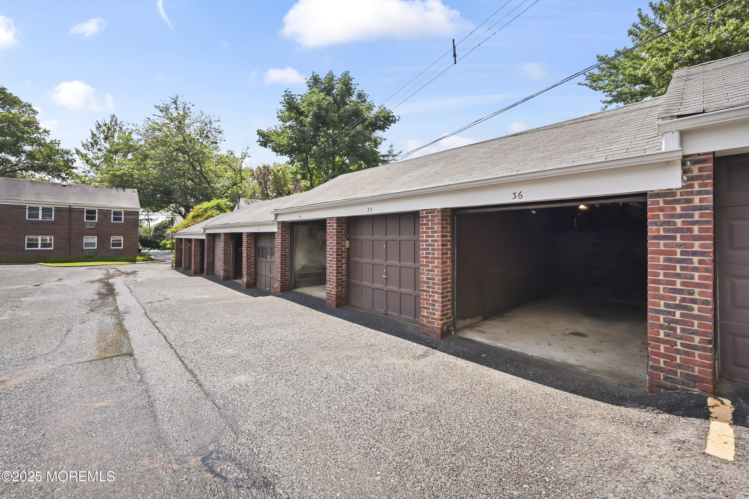 82 Manor Drive, Unit 803 Red Bank, NJ 07701 - Photo 17 of 19 a front view of a house with a yard and garage