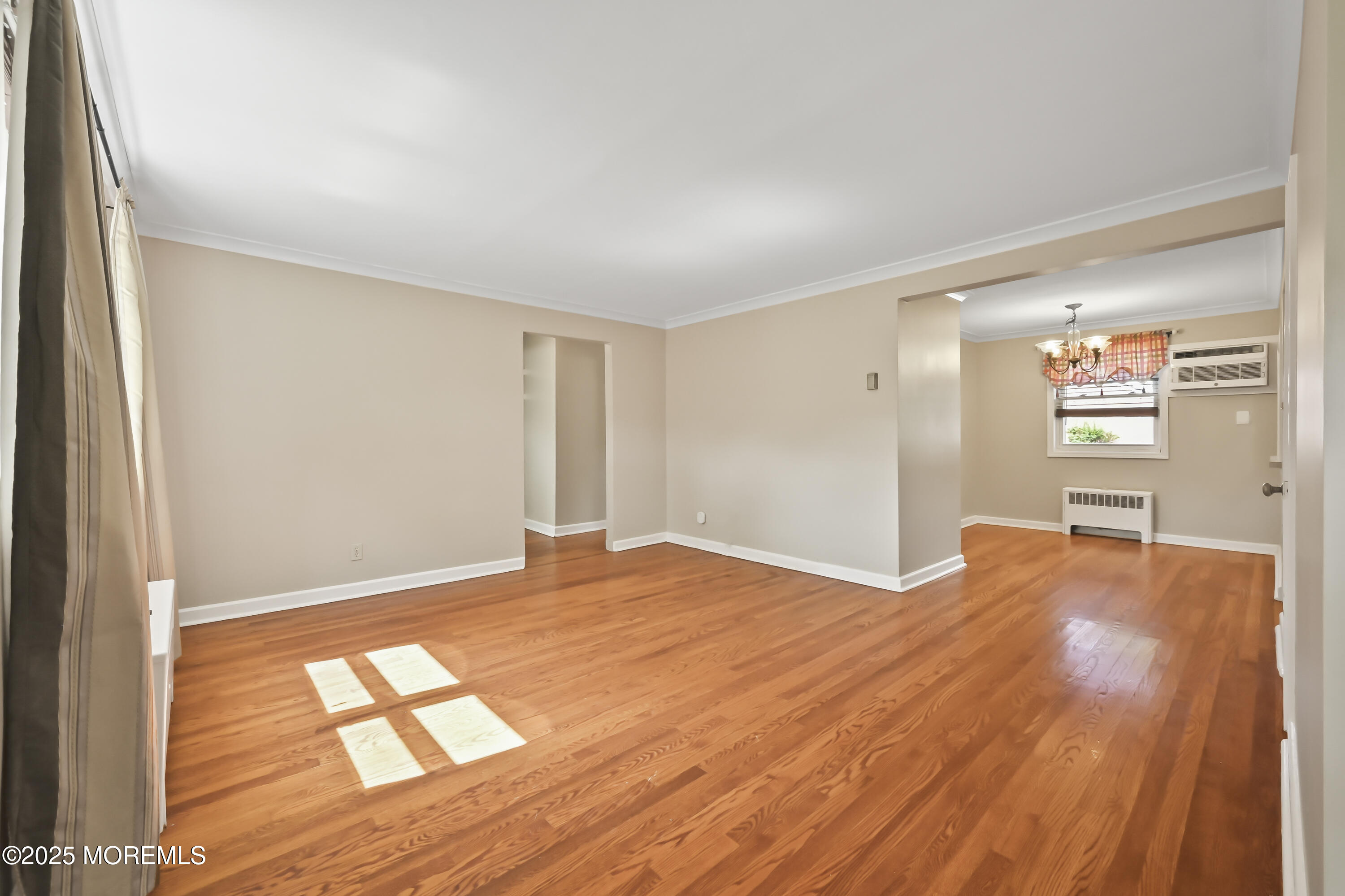 82 Manor Drive, Unit 803 Red Bank, NJ 07701 - Photo 4 of 19 a view of empty room with wooden floor and fan