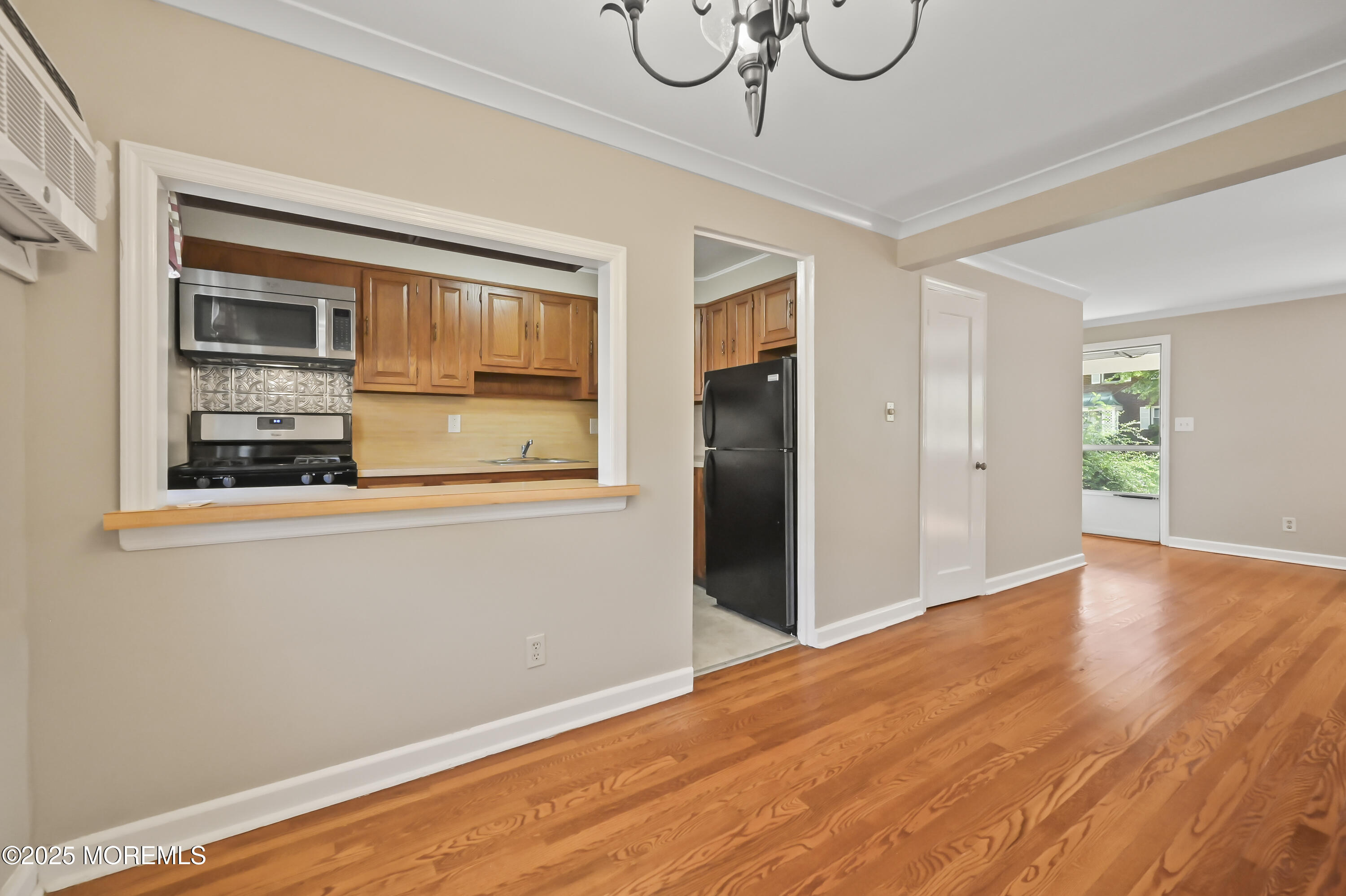 82 Manor Drive, Unit 803 Red Bank, NJ 07701 - Photo 8 of 19 a view of empty room with wooden floor and windows