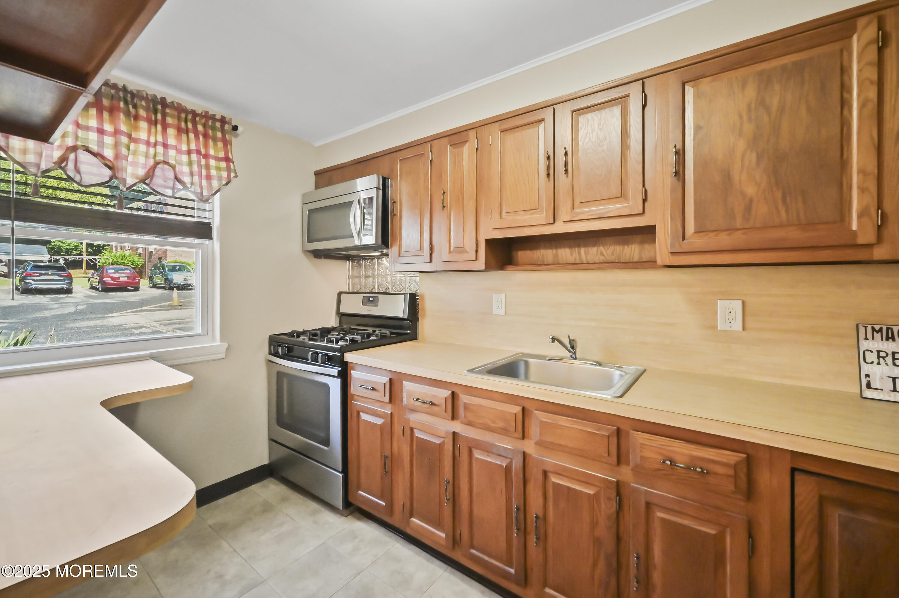 82 Manor Drive, Unit 803 Red Bank, NJ 07701 - Photo 9 of 19 a kitchen with stainless steel appliances granite countertop a sink and a stove