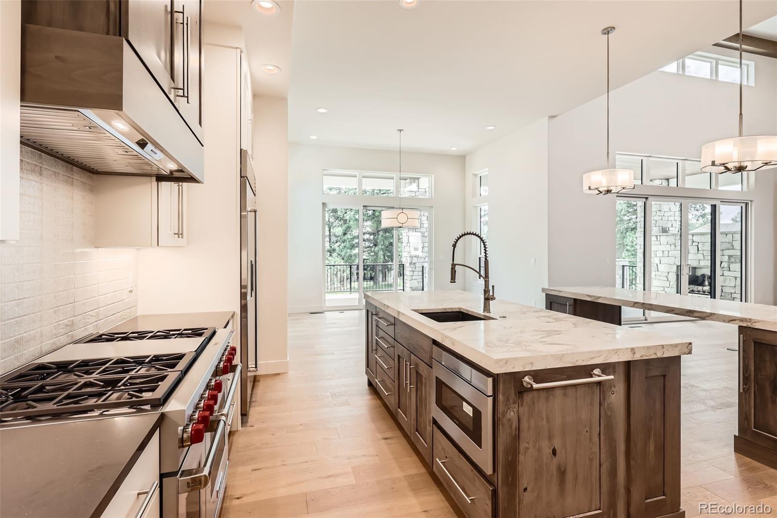 5841 Powell Road Parker, CO 80134 - Photo 13 of 50 a kitchen with a stove and a sink