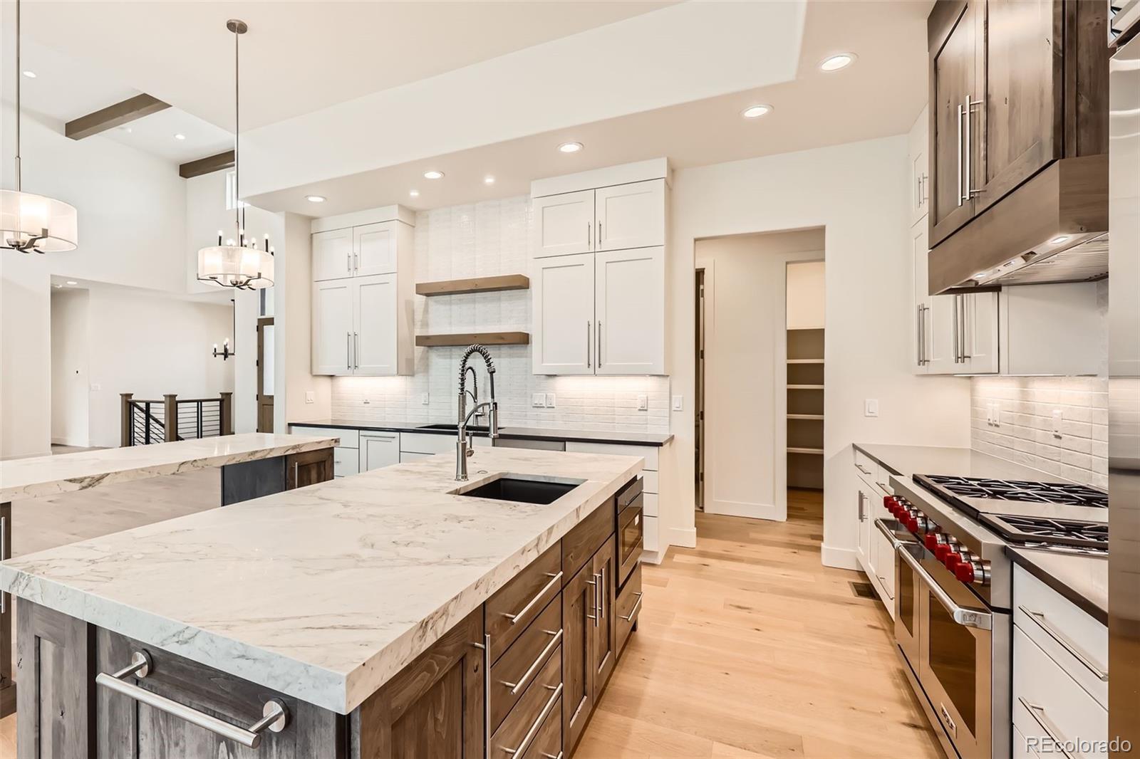 5841 Powell Road Parker, CO 80134 - Photo 14 of 50 a kitchen with stainless steel appliances a stove a sink a refrigerator and a refrigerator