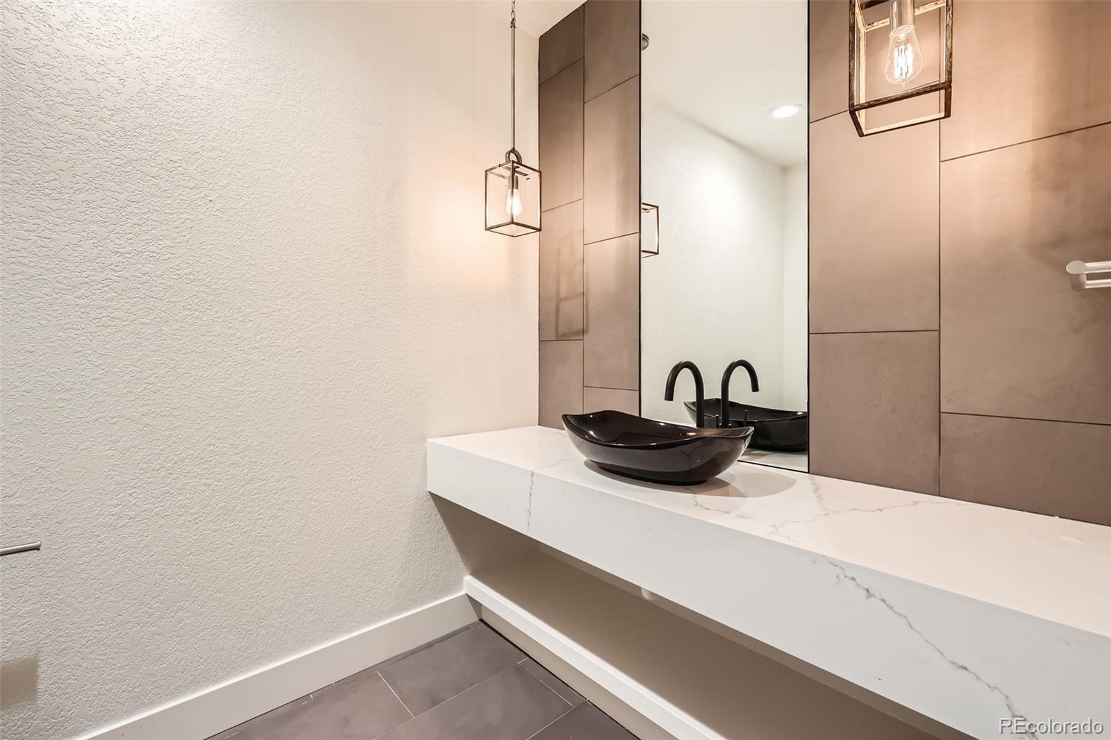 5841 Powell Road Parker, CO 80134 - Photo 17 of 50 a close view of a sink and a mirror in a bathroom