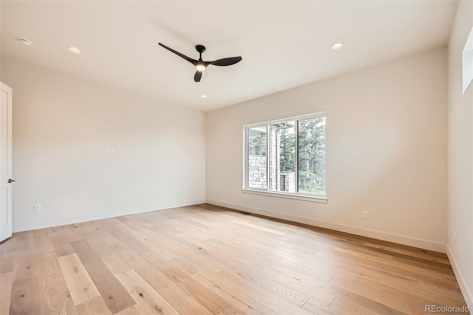 5841 Powell Road Parker, CO 80134 - Photo 19 of 50 wooden floor in an empty room with a window
