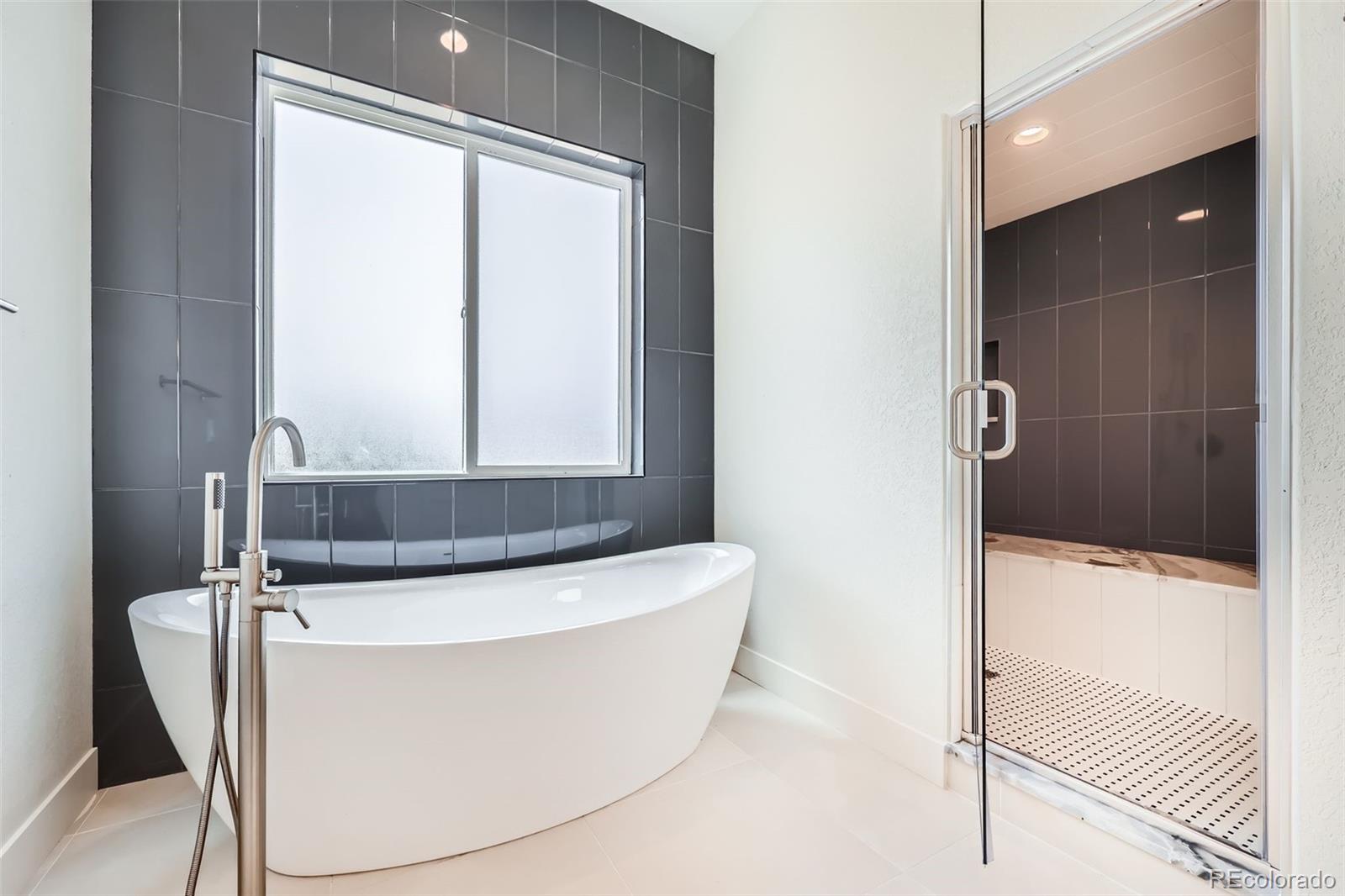 5841 Powell Road Parker, CO 80134 - Photo 22 of 50 a white bath tub sitting in a bathroom