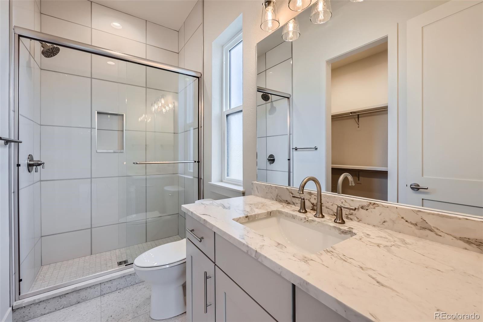 5841 Powell Road Parker, CO 80134 - Photo 26 of 50 a bathroom with a sink toilet and shower