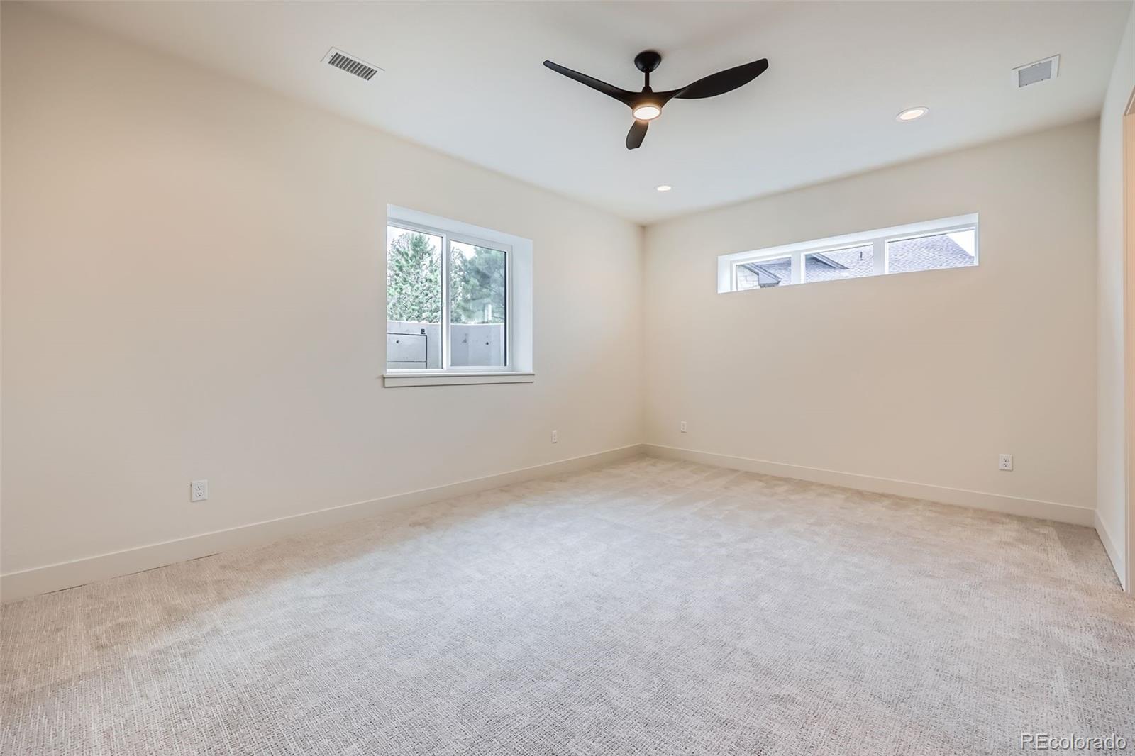 5841 Powell Road Parker, CO 80134 - Photo 27 of 50 an empty room with a window and a fan