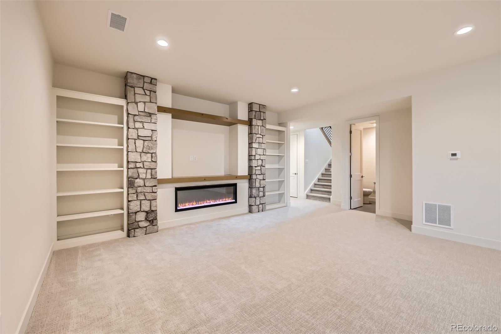 5841 Powell Road Parker, CO 80134 - Photo 32 of 50 a view of an empty room with a fireplace